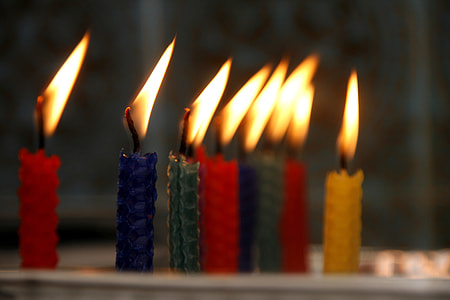 selective focus photography of two lighted blue and green rebar-style taper candles thumbnail