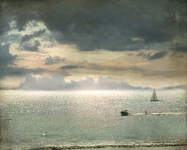 white sail boat on body of water thumbnail