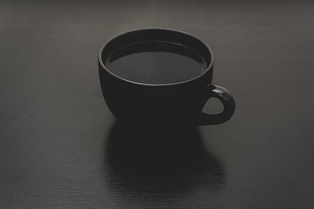 black ceramic coffee mug filled with liquid thumbnail
