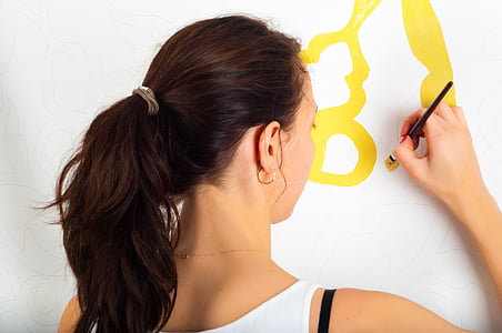 woman holding paintbrush photo thumbnail