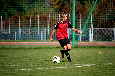 boy playing soccer on soccer field thumbnail