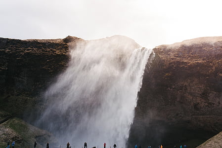 group of people near raging waterfalls thumbnail