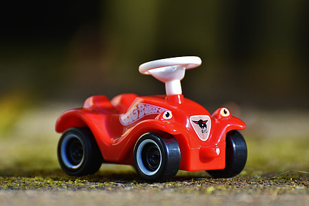 selective focus photography of red car plastic toy thumbnail