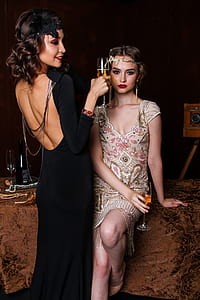 woman wearing black backless dress holding wine glass thumbnail