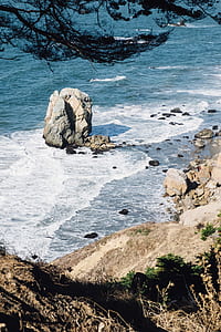 landscape photography of sea waves with rock formation thumbnail