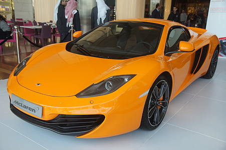 orange McLaren coupe inside showroom thumbnail
