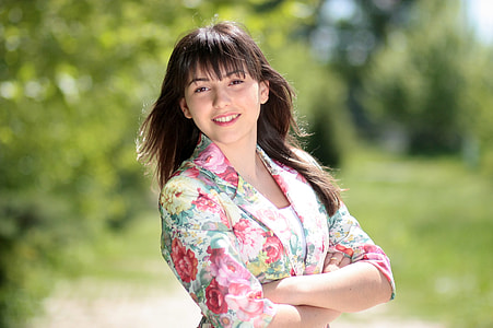 woman in pink and yellow floral blazer standing thumbnail