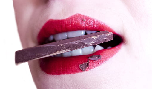 Woman Biting Brown Chocolate thumbnail