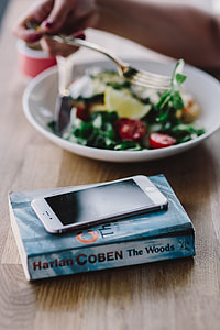 Woman eating breakfast and reading a book thumbnail