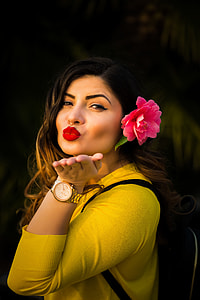 woman in yellow sweater and wearing gold-colored chronograph watch thumbnail