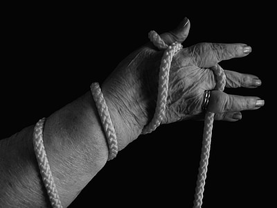grayscale photo of woman holding rope thumbnail