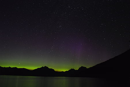 silhouette photography of mountains and aurora lights thumbnail