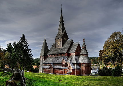 black and brown church surrounded by green trees thumbnail