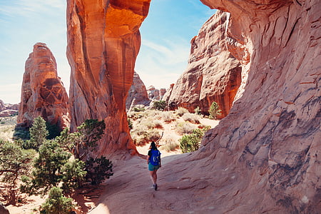 person walking near rock formations thumbnail