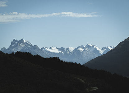 snow capped mountain under white clouds and blue sky thumbnail