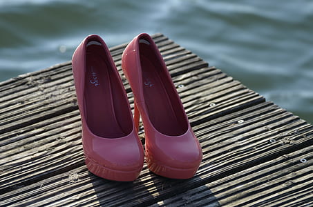 pair of pink patent leather heeled platform shoes on deck thumbnail