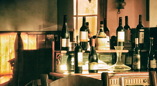 assorted-brand of glass bottles on table thumbnail