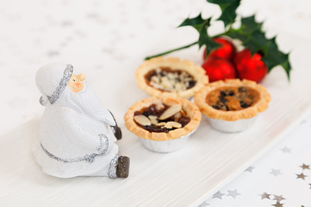selective focus photo of Santa Claus figurine beside pastry foods thumbnail
