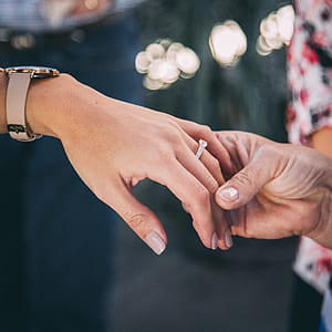 close-up photography of man holding woman's hand thumbnail