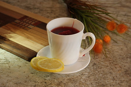 white teacup and saucer with sliced lemon thumbnail