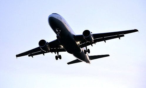 black and white passenger plane flying under clear sky thumbnail