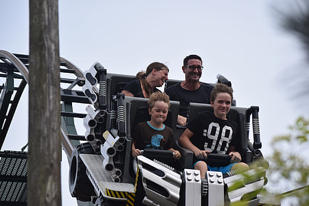 family of four riding roller coaster thumbnail