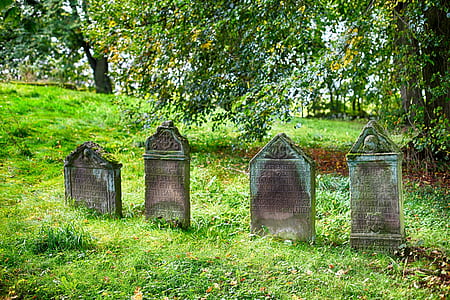 four gray concrete graves thumbnail