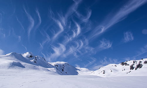 snow field under cloudy sky during daytime thumbnail