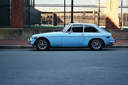 blue coupe parked on side walk thumbnail