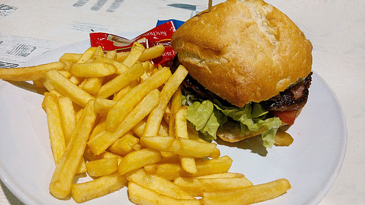 fries and burger on top of white ceramic plate thumbnail