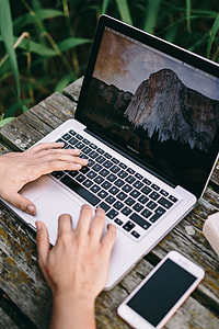 Man working on Macbook at lake thumbnail