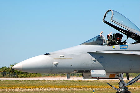 man waving hands inside jet plane at daytime thumbnail