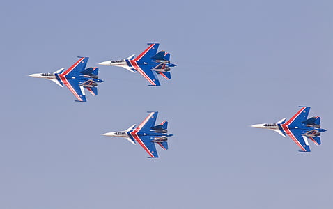 four white-blue-red flying jet planes thumbnail