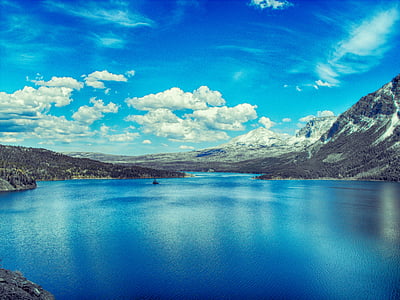 landscape photography of body of water surrounded by mountains thumbnail