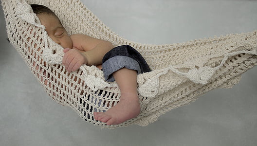 baby on white knit hammock thumbnail