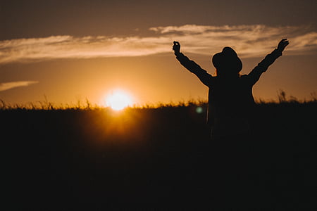 silhouette of woman raising hands thumbnail