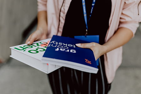 The woman is holding books in her hands thumbnail