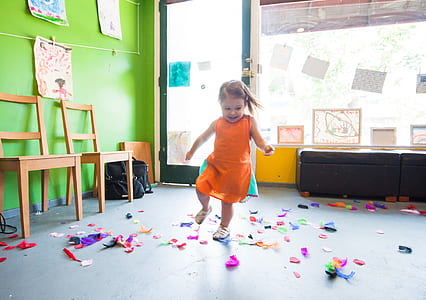 girl playing with confetti inside room thumbnail