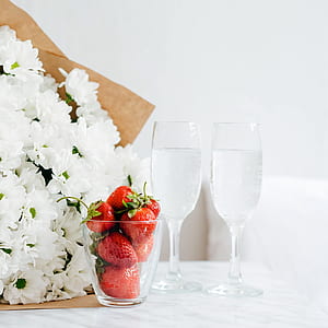 strawberries beside white flowers thumbnail
