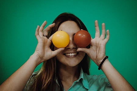 woman holding brown and yellow balls thumbnail