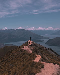 man standing on green mountain thumbnail