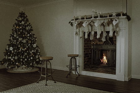 turned on fireplace near Christmas tree thumbnail