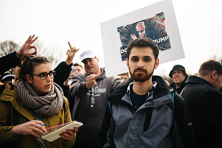man standing on crowd during daytime thumbnail