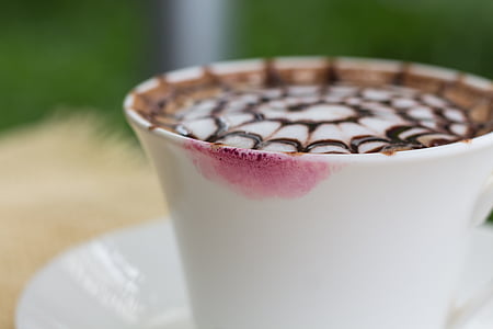 close-up photography of cappuccino filled white ceramic mug with pink lipstick stain thumbnail