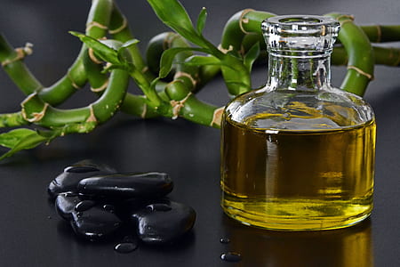black stone beside glass of oil thumbnail