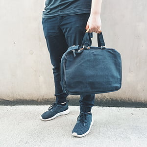 person holding handbag thumbnail