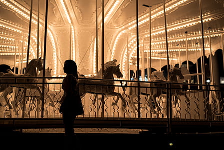 Girl Standing Near Carousel thumbnail