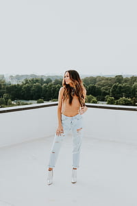 woman standing on roof posing during daytime thumbnail