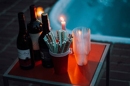 assorted wine bottles on red wooden table thumbnail