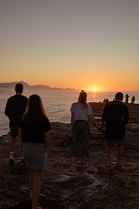 two men and women standing near seashore thumbnail